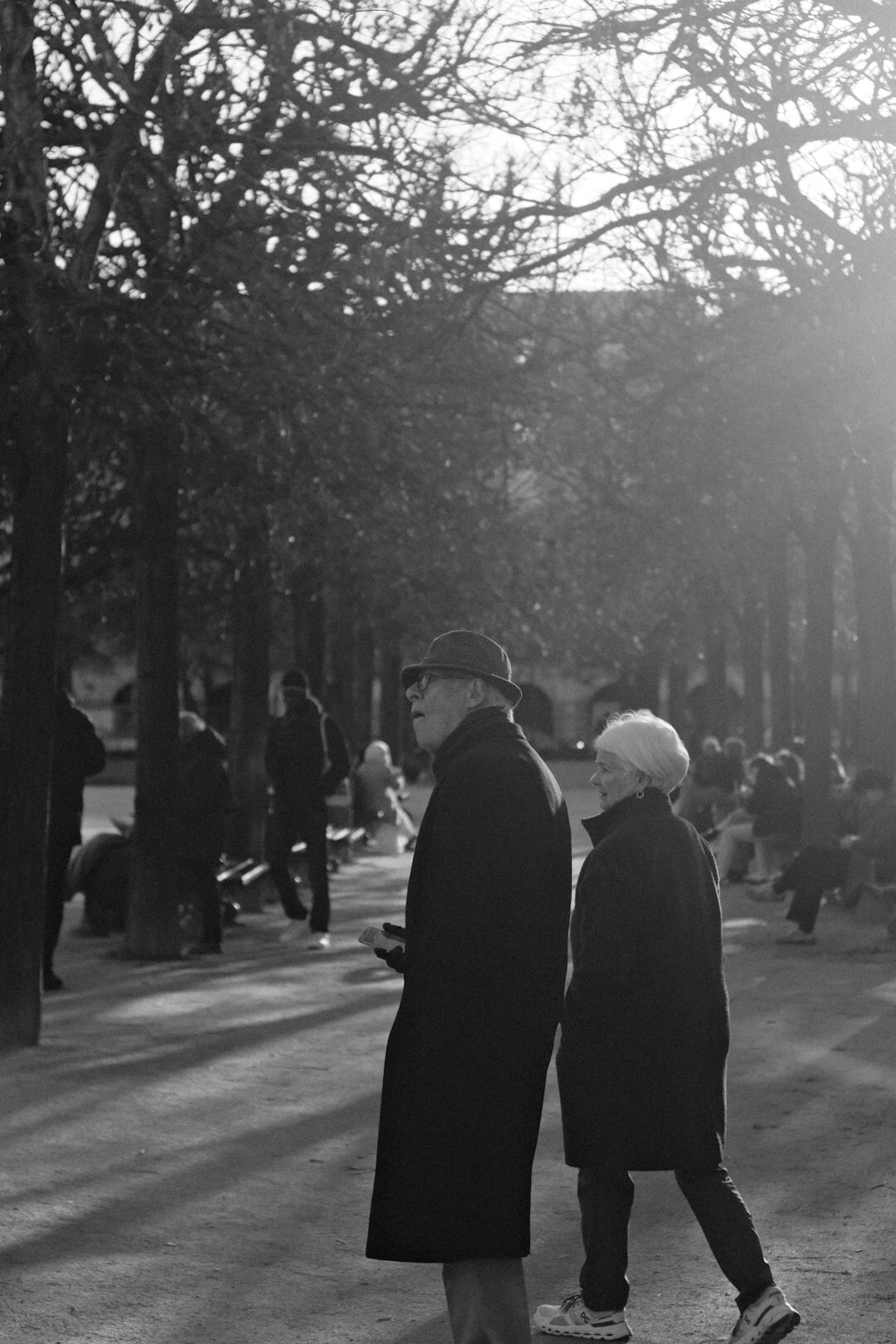 elderly couple walking in park