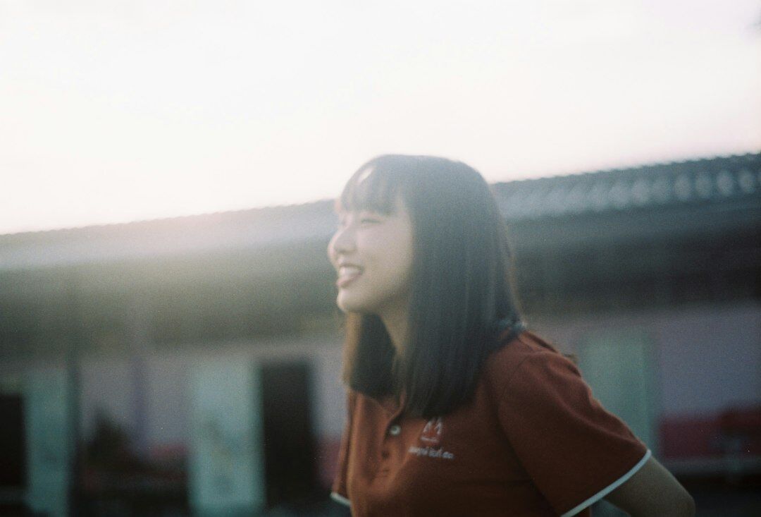Portrait of a friendly Japanese woman staff member smiling
