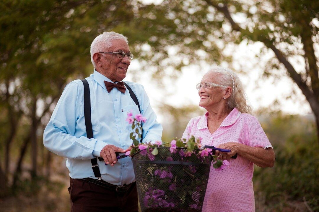 elderly couple walking in park