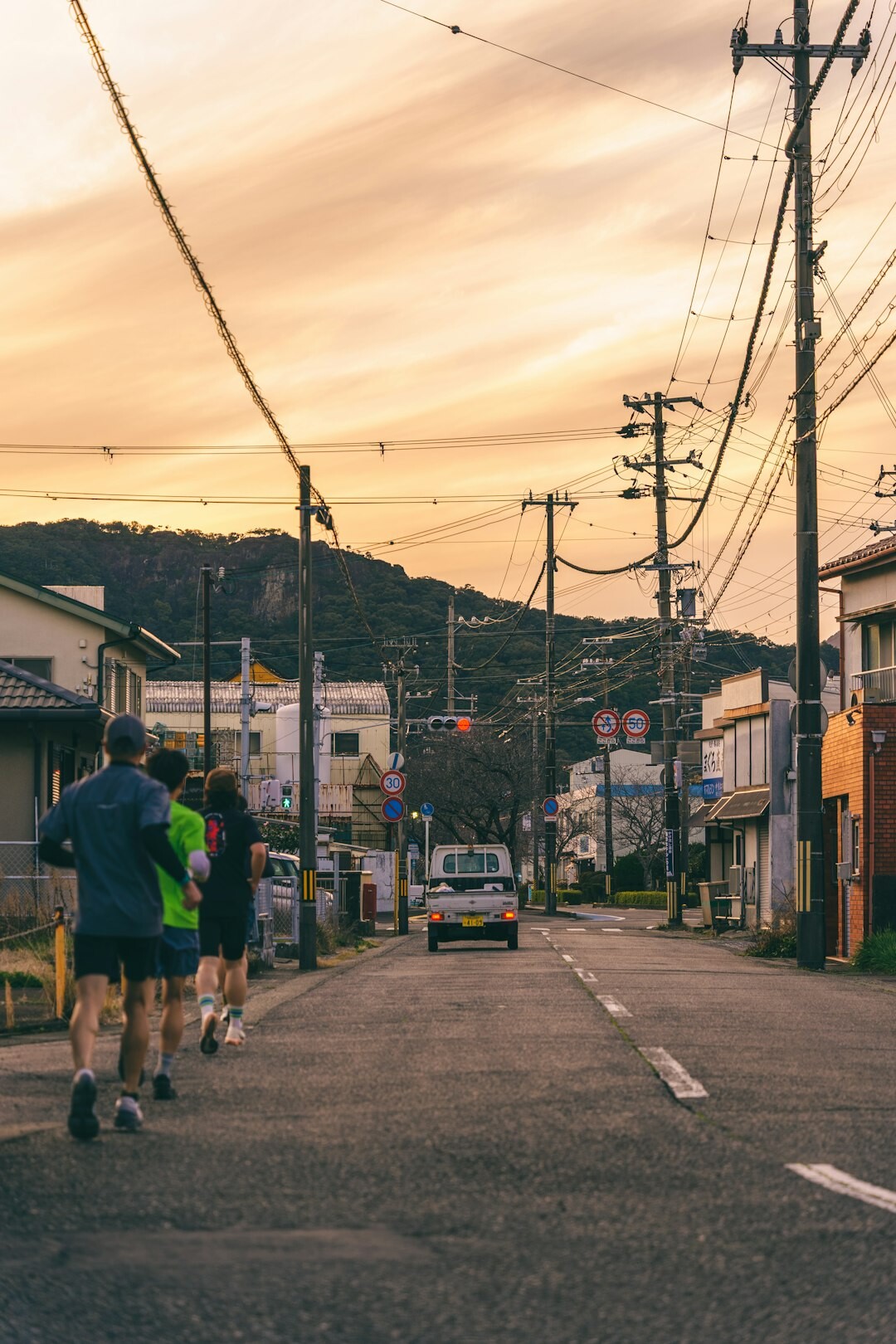 Group of active Japanese seniors doing morning exercise outdoors
